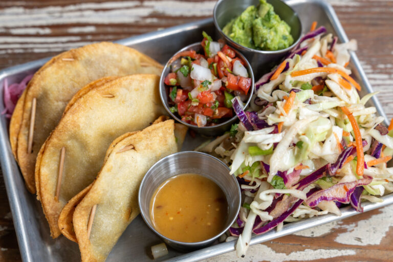 Three Taco Plate: Hushwe Taco, Papas Taco, Spicy Cauliflower Taco, Slaw, Pico de Gallo, Guacamole, Situ Salsa. Photo by Star Chefs.